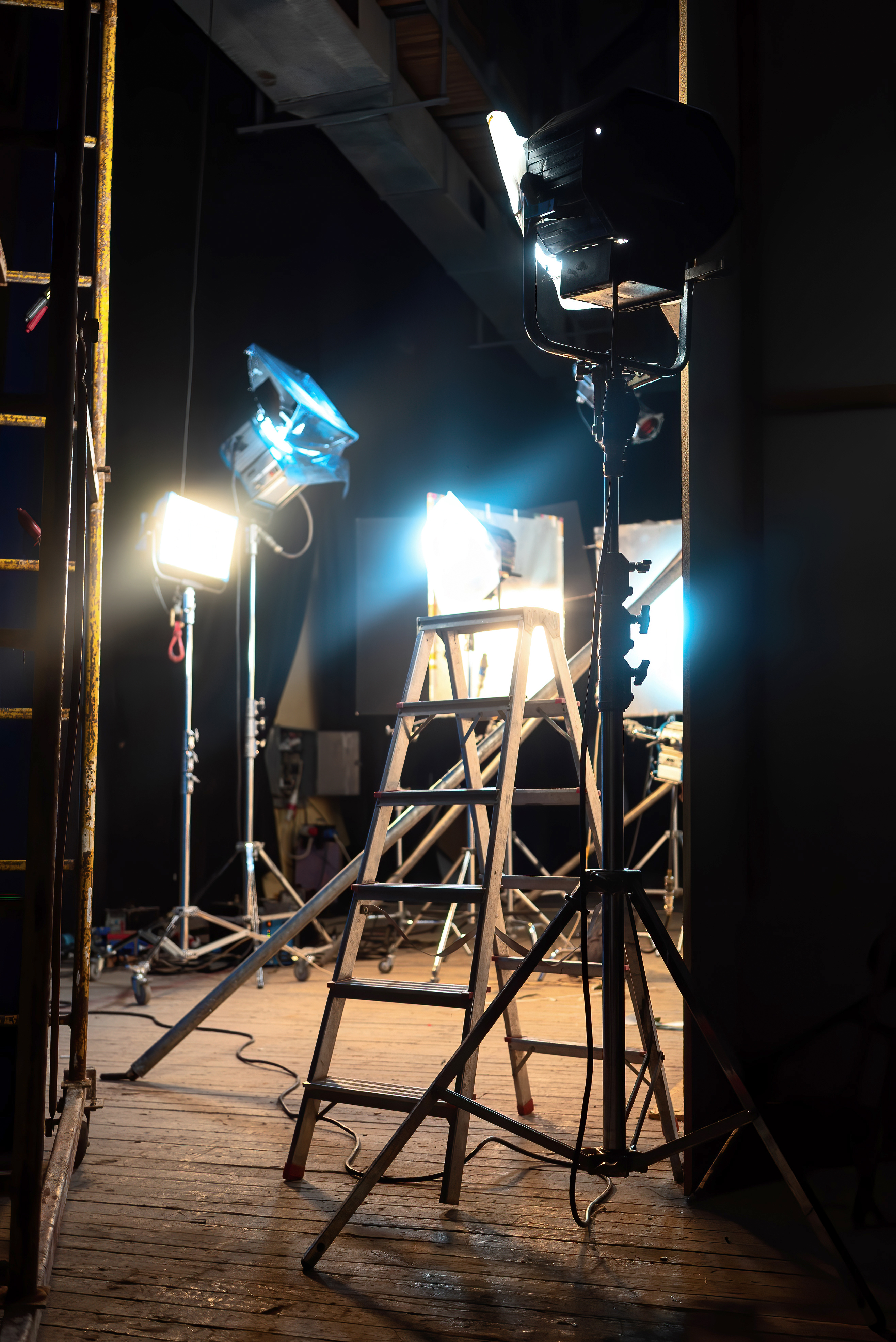 Lots of led lightning systems, few with color filters, stairs on the foreground in pavilion, movie set